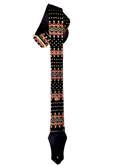 The Indochine guitar and bass strap in black with a golden and red pattern.